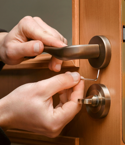 Person rekeying a door lock